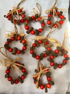 some red berries are tied to twine and placed on a white towel with burlap