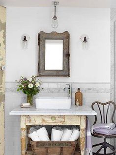 a bathroom with a sink, mirror and wooden crate under the faucet in it