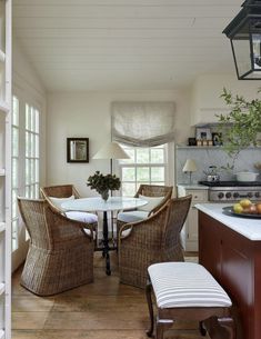 a dining room and kitchen area with white walls