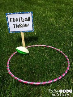 a sign that says football throw on top of a hula hoop in the grass