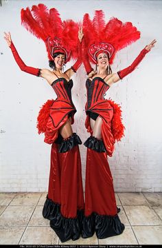 two women dressed in red and black posing for the camera