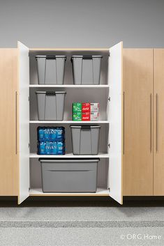 an open cabinet with plastic containers and bins