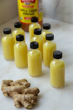 Glass bottles of ginger shots surrounded by sliced lemons and a bottle of apple cider vinegar, capturing the essence of wellness. Diy Ginger Shots, Lemon Ginger Shots, Cocktails Girls Night, Restaurants Aesthetic, Cocktails Thanksgiving, Girls Night Cocktails, Aesthetic Locations, Aesthetic Bachelorette