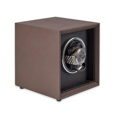 a watch winder in a brown leather case