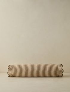 a striped pillow sitting on top of a white table