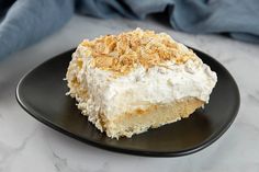 a piece of cake sitting on top of a black plate