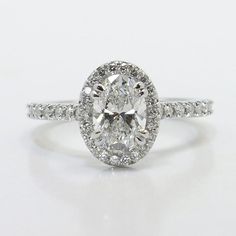 an oval cut diamond ring with pave set shoulders