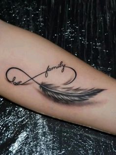 a black and white photo of a tattoo with the word family written in cursive writing