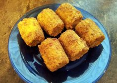 some food is on a blue plate on a counter top and it looks like they are made out of cornbreads