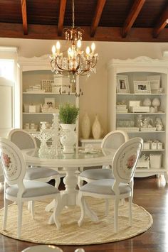 a dining room table with chairs and a chandelier