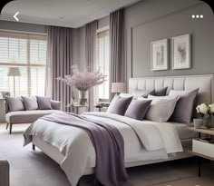 a bedroom with gray walls and white bedding