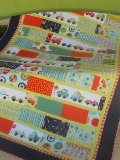 a quilted table runner with cars and trucks on it