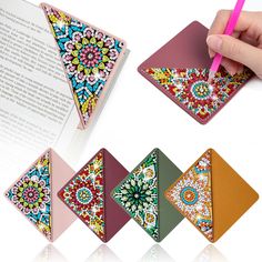 a person is writing on a book with colorful designs