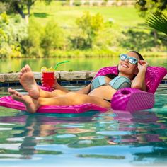 a woman relaxing in the pool with a drink