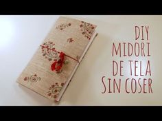 a small book with red ribbon tied to it's cover and the words diy midori de tela sin coser