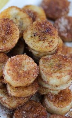 some bananas are sitting on a plate with powdered sugar and cinnamon sprinkled around them