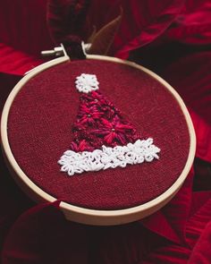 a red and white christmas tree ornament in a hoop