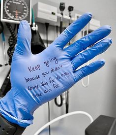 a glove that has writing on it in the middle of a room with other medical equipment