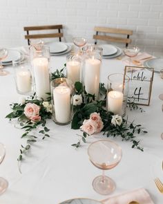 a table topped with lots of candles and flowers