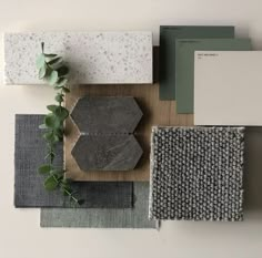 various materials are arranged on top of each other, including tiles and rugs with green leaves