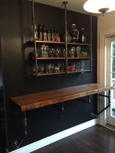 an empty room with shelves and glassware on the wall next to a sliding glass door