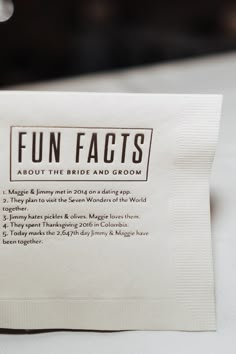 a close up of a napkin on top of a white table cloth with words written in it