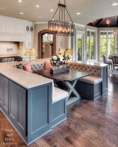 a large kitchen with an island in the middle and lots of seating on top of it