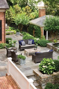 an outdoor living area with couches, chairs and tables in the middle of it