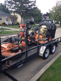 a trailer loaded with lawn mowers and other equipment