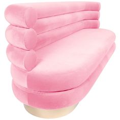 a pink couch sitting on top of a white table