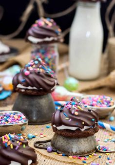 chocolate covered desserts with sprinkles and confetti on the table