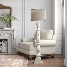 a living room with a chair, lamp and mirror on the wall next to a fireplace