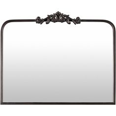 a mirror with an ornate design on the top and bottom frame, hanging from a wall