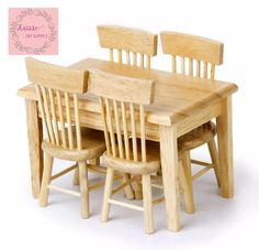 a wooden table with four chairs and a sign