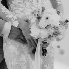 the bride and groom are holding each other's wedding bouquets in their hands