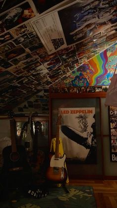 a room filled with guitars and pictures hanging from the ceiling above it's head