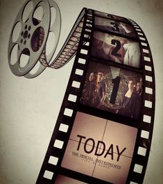 a film strip with the words today on it and four movie reels attached to it