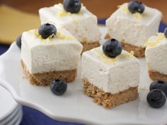 small desserts with blueberries and cream on a white plate