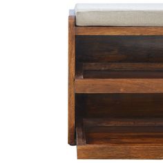 a wooden book shelf with a cushion on top