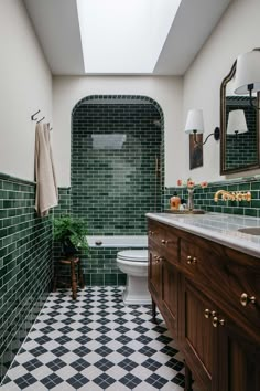 a bathroom with green tiles on the walls and floor