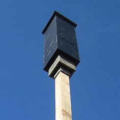 a clock tower with a blue sky in the back ground and no one around it