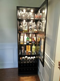 the liquor cabinet is filled with bottles and glasses