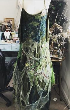 This one of a kind made to order dress is a beautiful amalgamation of everything beautiful and magical about the woods and beautiful earth greens with tones of browns and cobwebs silver because covers the front with various elements that dangle throughout as I've collected over the years by fairies this dress is 100% magical and very comfortable extremely lightweight with a pull over design it fits anywhere from an extra extra small on way up to a 2X large it is a one-of-a-kind item and will tru Fairycore Green Dress For Costume Party, Green Fantasy Dress For Costume Party, Whimsical Green Dress For Costume Party, Fairy Style Green Dress For Costume Party, Green Fairy Dress For Costume Party, Dress With Wings, Fairy Clothes, White Witch, Green Earth