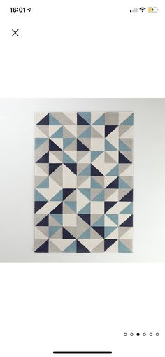 an image of a blue and white rug with triangles on it