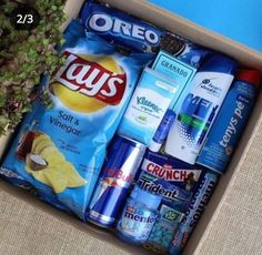 a box filled with lots of different types of snacks and condiments on top of a table