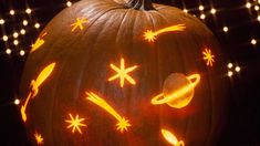 a carved pumpkin with an image of saturn on it