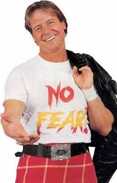 a man wearing a shirt that says no fear with an image of the wrestler on it