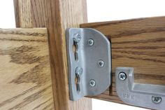 a close up of a wooden door with a metal latch on it's side