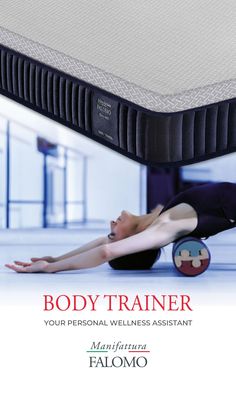 a woman laying on the ground next to a body trainer mattress