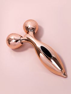 two shiny metal objects on a pink background